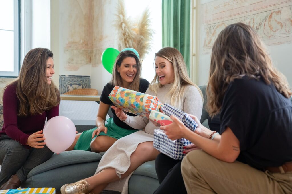 women giving presents to an expecting mom