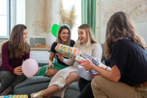 women giving presents to an expecting mom